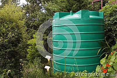 Large water storage tank in a garden Stock Photo