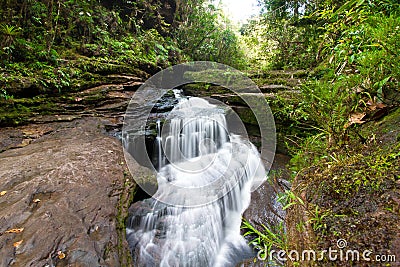 A large waterfall over some water el fin del mundo Stock Photo