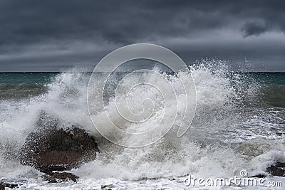 A large wave breaks on a rock Stock Photo