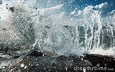 Large Waves Crash into Rock Tide pools, Throwing Foamy White Seawater Spray Into The Air In Storm Stock Photo