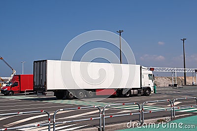 Large white lorry speeding from ferry Stock Photo