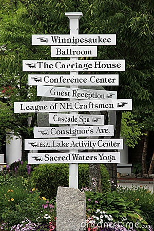 Large white sign post with directions around town,Lake Winnipesaukee,Summer,2014 Editorial Stock Photo