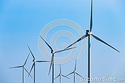 Large wind turbines moving to create kinetic energy for renewable energy supply Stock Photo