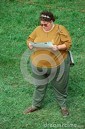 A large woman reading a pamphlet Editorial Stock Photo