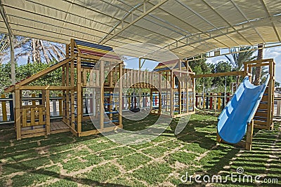 Large wooden climbing frame in children`s playground area Stock Photo
