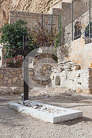 A large wooden cross near the grave in the cemetery in the monastery of St. George Hosevit Mar Jaris near Mitzpe Yeriho in Israe Editorial Stock Photo