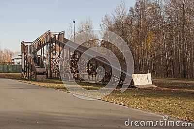 Large wooden slide for sleds. Empty inactive in the autumn Stock Photo