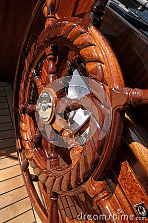 Large wooden steering wheel of a classical sailing yacht. Stock Photo