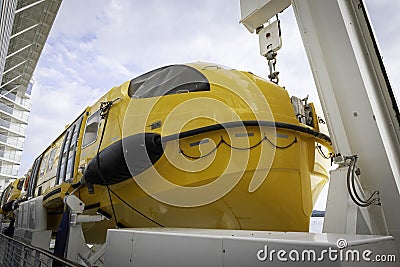 Large yellow lifeboat on side of cruise ship Editorial Stock Photo