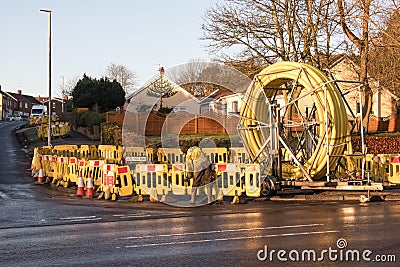 Large yellow piping on a spool with safety barriers for gas works Editorial Stock Photo