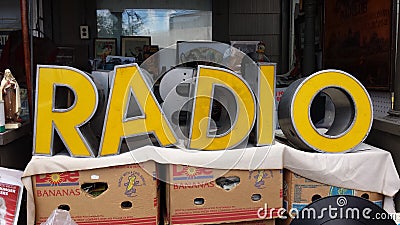 Large Yellow Vintage Letters that Spell RADIO Seen at an Antique Show Editorial Stock Photo