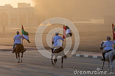 Largest Military Show at Marjan Island with coordinated military event with horses riding down the street and UAE flags landing in Editorial Stock Photo