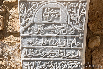 LARNACA, CYPRUS, MARCH, 2019: Tombstones of Turkish commanders in the fort of Larnaca. Some unknown writings on white stones. Old Editorial Stock Photo