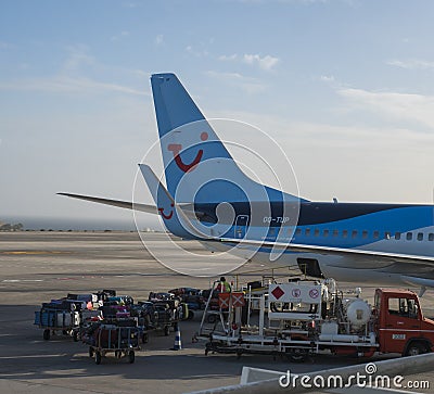 Las Palmas de Gran Canaria, Canary Islands, Spain December 26, 2020: Unloading luggage from Tui airline plane to baggage Editorial Stock Photo