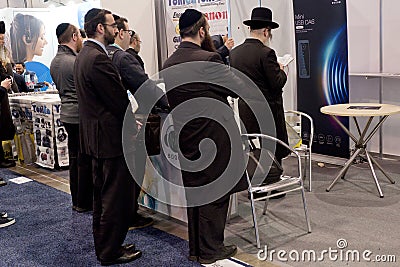 Men in black coats during an afternoon prayer at CES Editorial Stock Photo