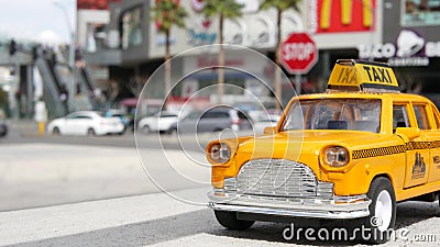 LAS VEGAS, NEVADA USA - 7 MAR 2020: Yellow vacant mini taxi cab close up on Harmon avenue corner. Small retro car model. Little Stock Photo