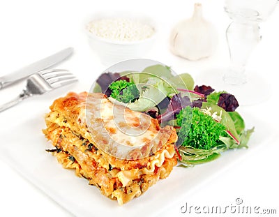 Lasagna on a Plate with Salad Stock Photo