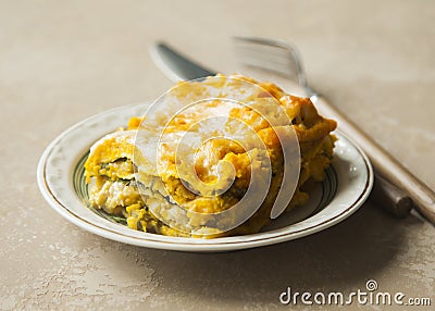 Lasagna with pumpkin, spinach and turkey meat on brown background. Stock Photo