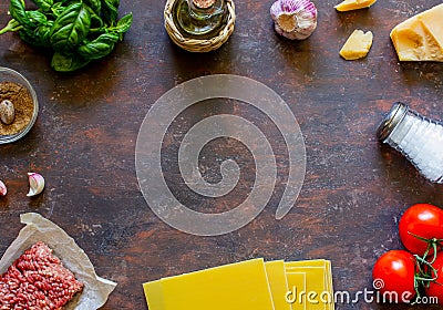 Lasagna, tomatoes, minced meat and other ingredients. Dark background. Italian cuisine Stock Photo