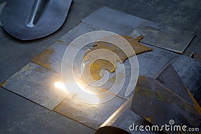 Laser cleaning of metal. The laser beam cleans the metal surface from rust. Stock Photo