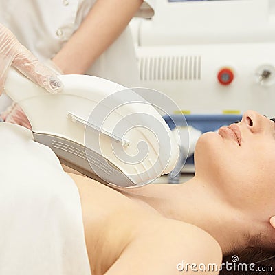 Laser elos medical device. Remove unwanted hair and asteriks. Cosmetology spa procedure at salon. Decollete laser depilation Stock Photo