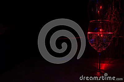 Laser light painting of wine glassful of water and bubble using laser diffraction Stock Photo