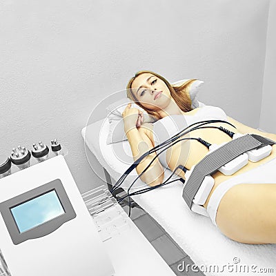 Laser lipo equipment. Cosmetic fat reduce treatment. Woman in medicine salon. Anti cellulite procedure Stock Photo