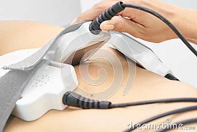 Laser lipo equipment. Cosmetic fat reduce treatment. Woman in medicine salon. Anti cellulite procedure Stock Photo