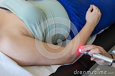 Laser therapy in hand used to treat pain. Stock Photo