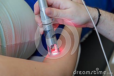 Laser therapy in hand used to treat pain. Stock Photo