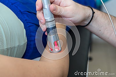 Laser therapy in hand used to treat pain. Stock Photo