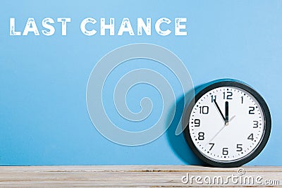 Last chance words on blue colored background with clock Stock Photo