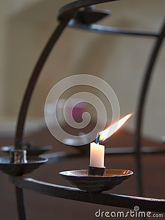 Last lonely candle in church. Stock Photo