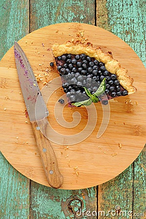 Last piece of homemade open pie decorated with fresh forest blue Stock Photo