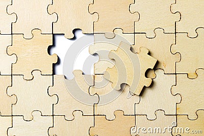 The last piece of a jigsaw wooden puzzle Stock Photo