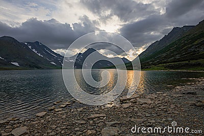 Last rays of sunset on the Hadatayoganlor lake. Polar Ural Stock Photo