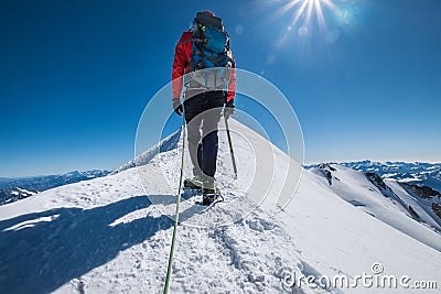 Last steps before Mont Blanc Monte Bianco summit 4,808 m of man with climbing axe dressed mountaineering clothes, boots with Stock Photo