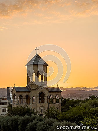 Late evening bright sunset sun rays enlighten through the small chapel arches near the Holy Trinity Cathedral of Tbilisi, Georgia Stock Photo