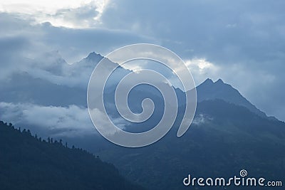 A late evening in the misty silhouettes of the mountains Stock Photo