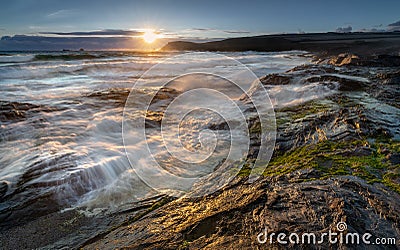 Late light catching surf over rocks, Constantine Bay, Cornwall Stock Photo