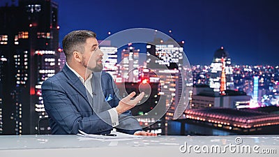 Late Night TV Talk Show Live News Program: Charismatic Male Anchor Presenter Reporting. Television Stock Photo