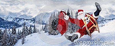 Late Santa claus in a hurry on sleigh sled with traditional red white costume and big gift bag in front of white snow winter Stock Photo