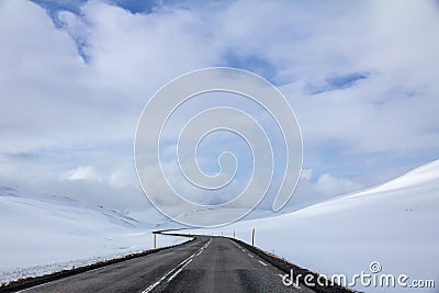 Iceland`s Circle Road winds through snow covered hills Stock Photo