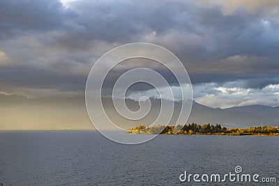 Late sunset at Ohrid lake with dark clouds Stock Photo