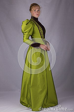 Late Victorian woman in green silk ensemble Stock Photo