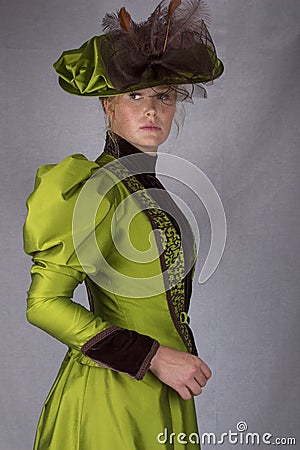 Late Victorian woman in green silk ensemble Stock Photo