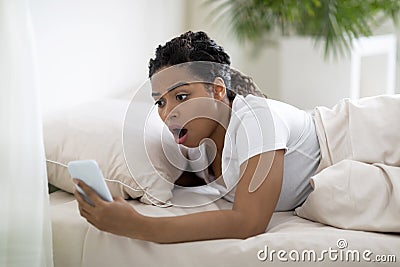 Late For Work. Shocked Overslept Black Woman Looking At Smartphone In Hand Stock Photo