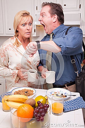 Late for Work Stressed Couple in Kitchen Stock Photo