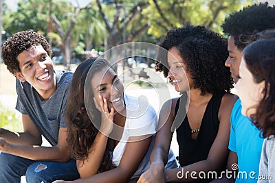 Later woman and african man talking with caucasian friends Stock Photo