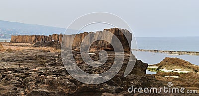 Lateral view of the phoenician wall of Batroun, Lebanon, which has been carved during antiquity period Stock Photo